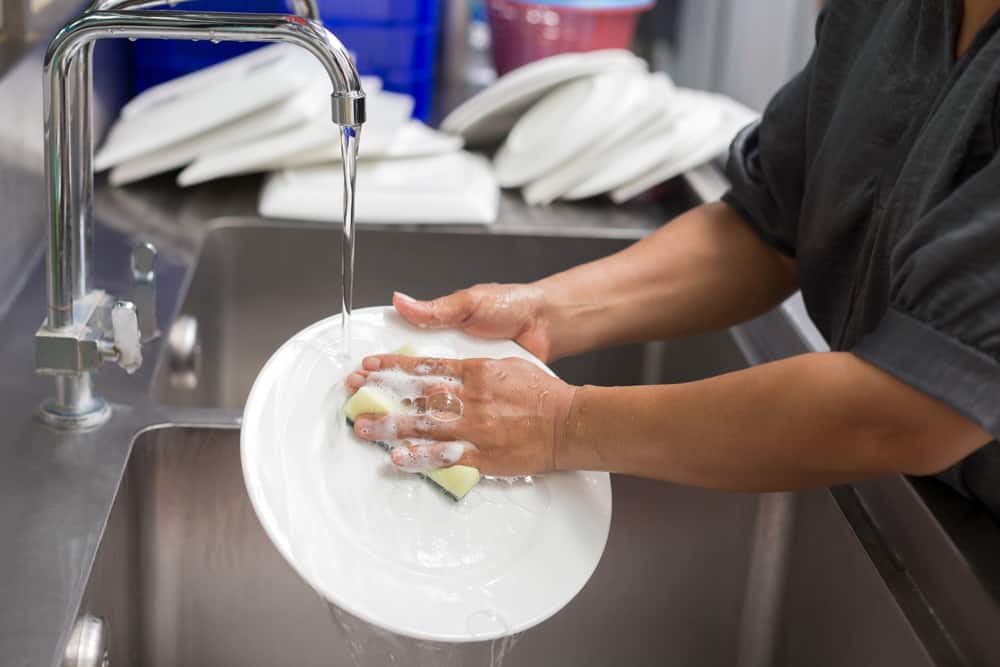 restaurant staff washing dishes in kitchen