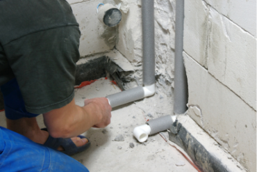 Plumber installing pipes