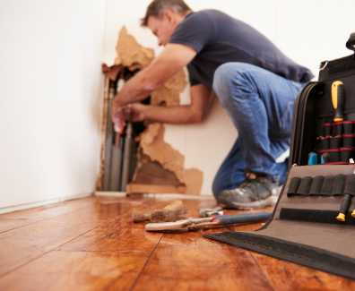 Middle Aged Man Repairing Burst Pipe,plumbing