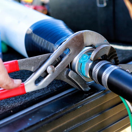 close up of plumbers hands mounting new submersible water pump