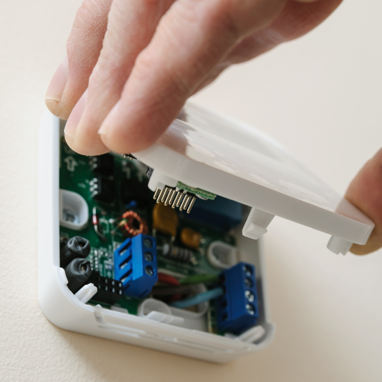 Installing a programmable room thermostat.